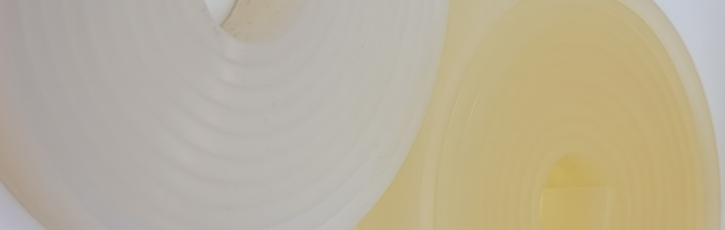 Comparison of two silicone rubber extrusions, one clear and one yellowed, showing how environmental or curing effects can cause silicone discolouration over time.